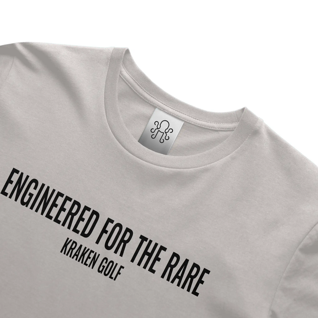 Kraken Golf gray t-shirt featuring the phrase "Engineered for the Rare" printed in bold black Oswald font across the chest.
