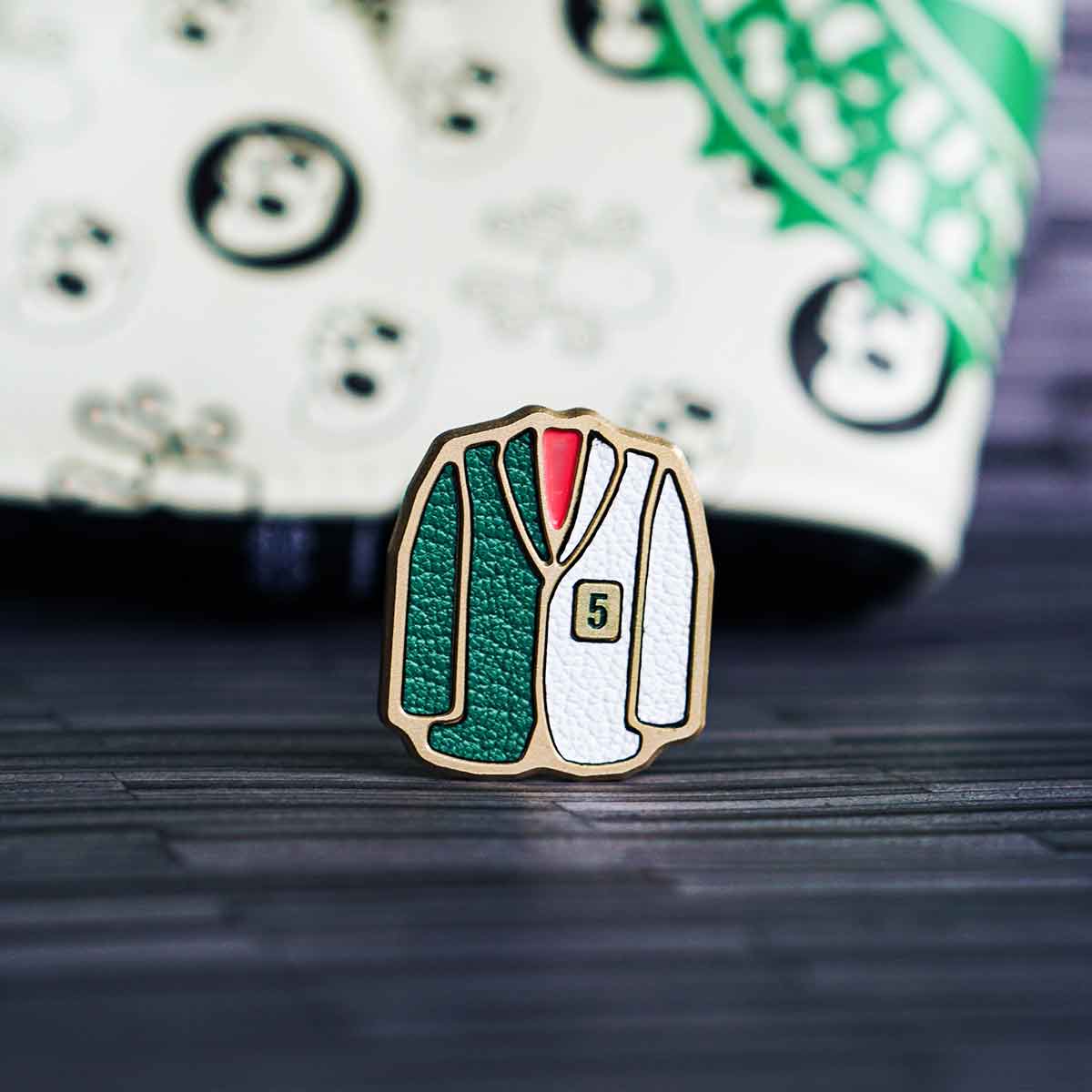 2025 Augusta Mix Marker - brass golf ball marker featuring green leather inlay shaped like the Masters jacket on one side and white caddy bib leather inlay on the reverse, handcrafted for collectors and Augusta fans.