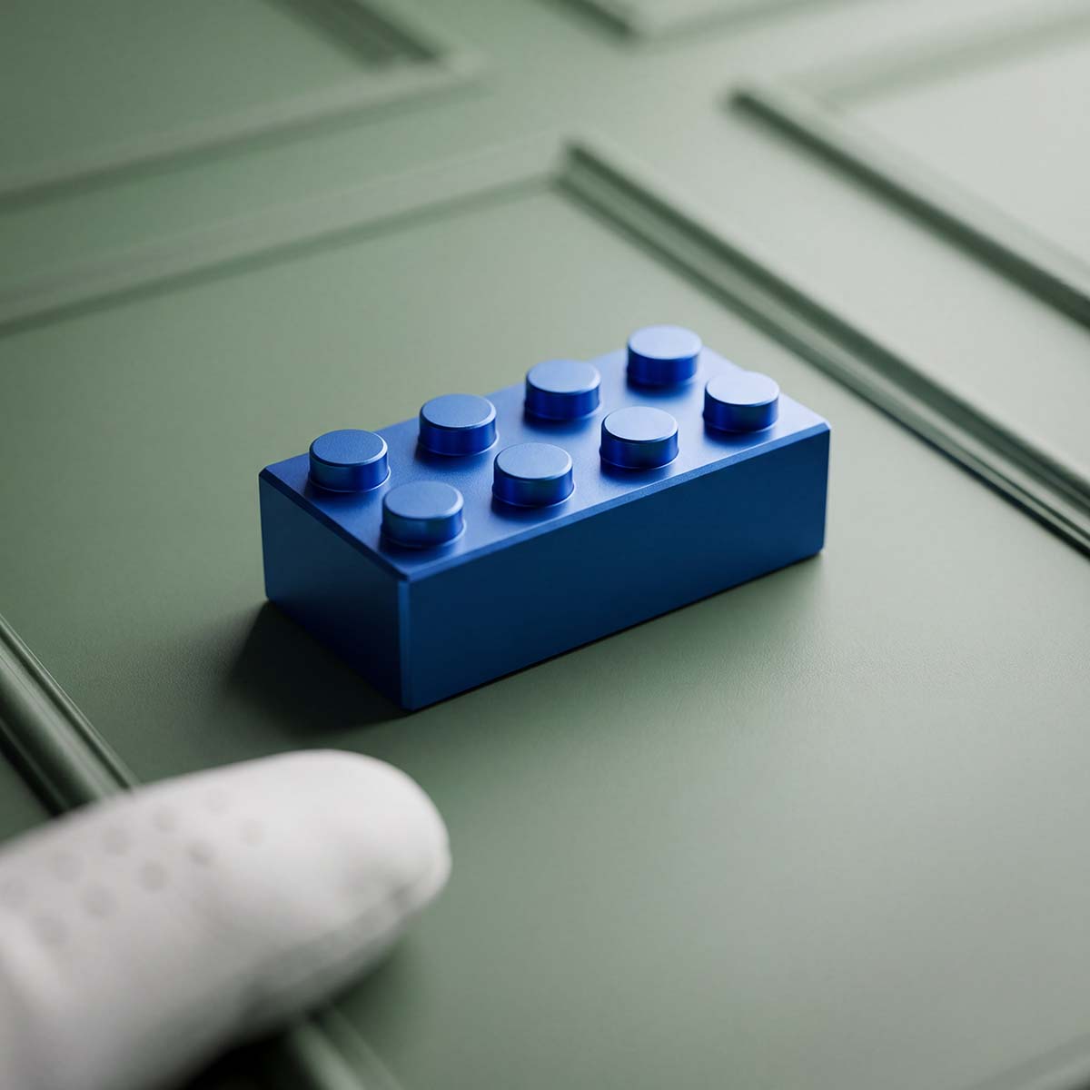 Macro shot of bead-blasted blue anodized finish and milled eight-stud silhouette