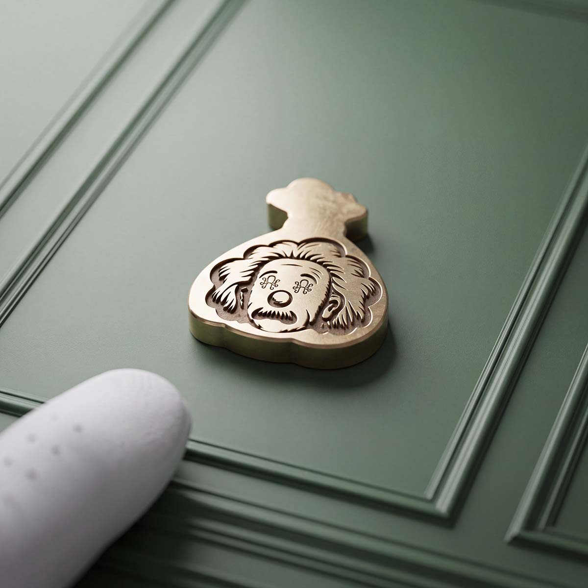 Reverse of Kraken Golf Compound brass ball marker showing an engraved Einstein face with signature Kraken eyes