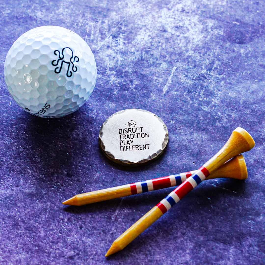 Hand-distressed brass golf ball marker with deep patina finish, engraved "Hobo Luck" design, and hammered edgework. Limited Kraken Golf release.