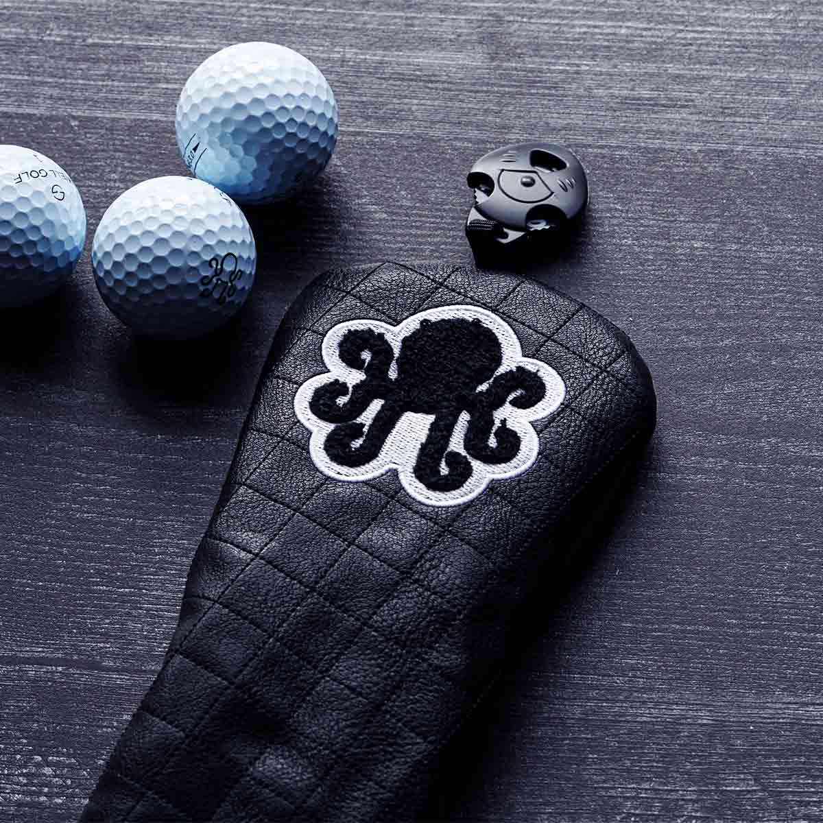 Black quilted fairway wood headcover from Kraken Golf Midnight Collection - chenille Kraken logo, white stitching
