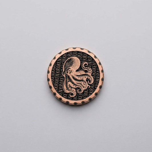 1.35 inch copper golf ball marker with blackened background repeating KRAKEN text