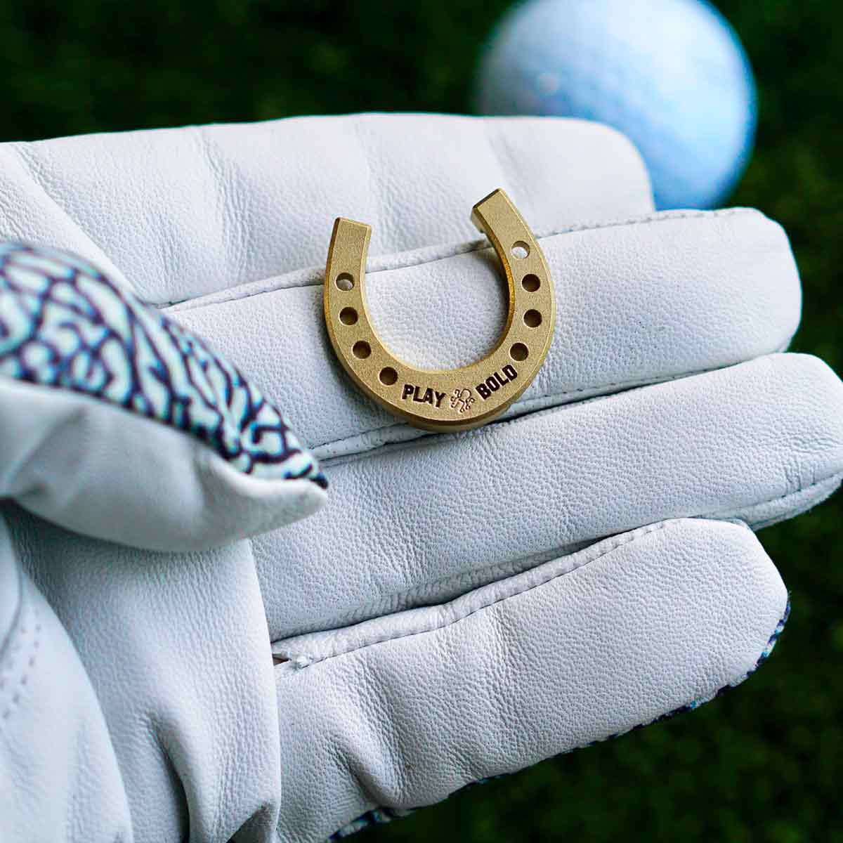 Engraved back of Lucky Horseshoe golf ball marker with Kraken logo