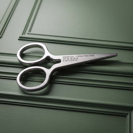 Back of Production Shears pitch tool showing laser-engraved Kraken Golf logo on brushed stainless steel