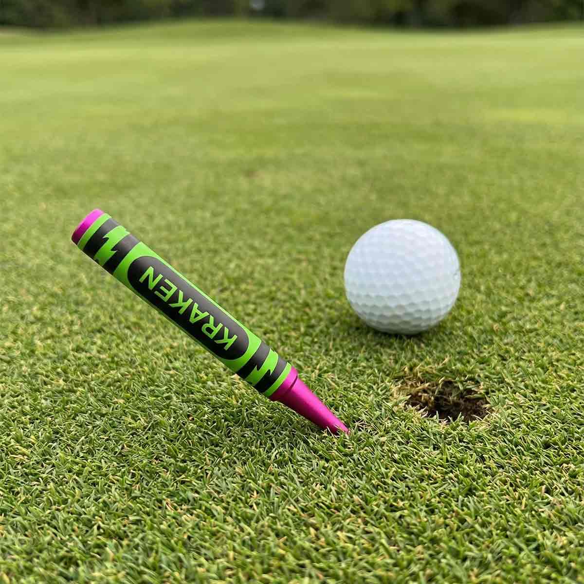 Golf ball with a Kraken pitch tool on a putting green