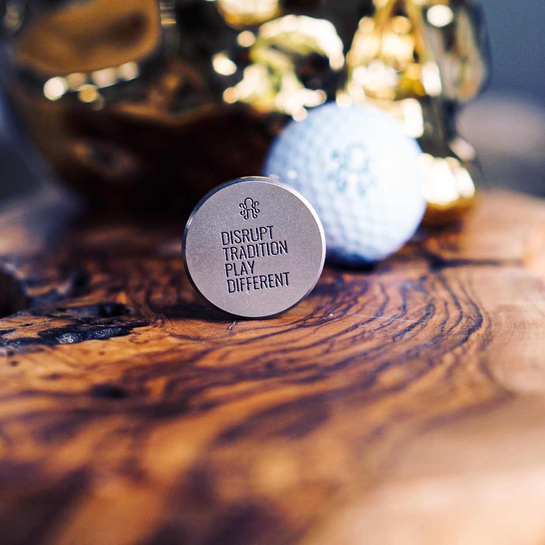 Close-up of The Autobahn Ball Marker crafted from stainless steel, accented with a premium Italian leather inlay for a high-performance, luxury golf accessory.