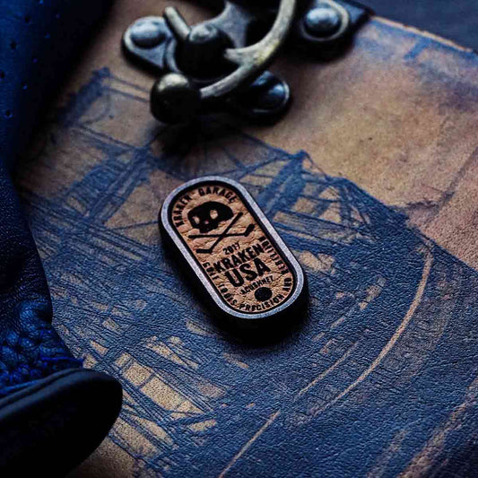 Copper golf ball marker with natural leather inlay and engraved Kraken skull logo