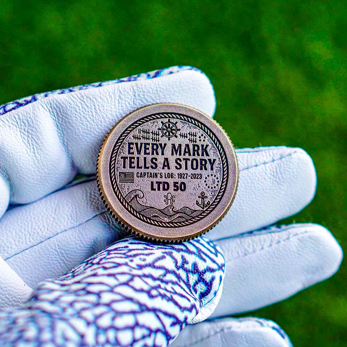 Engraved back of Ryder Cup golf ball marker with Every Mark Tells A Story, USA and Europe flags, and captains 1927-2023