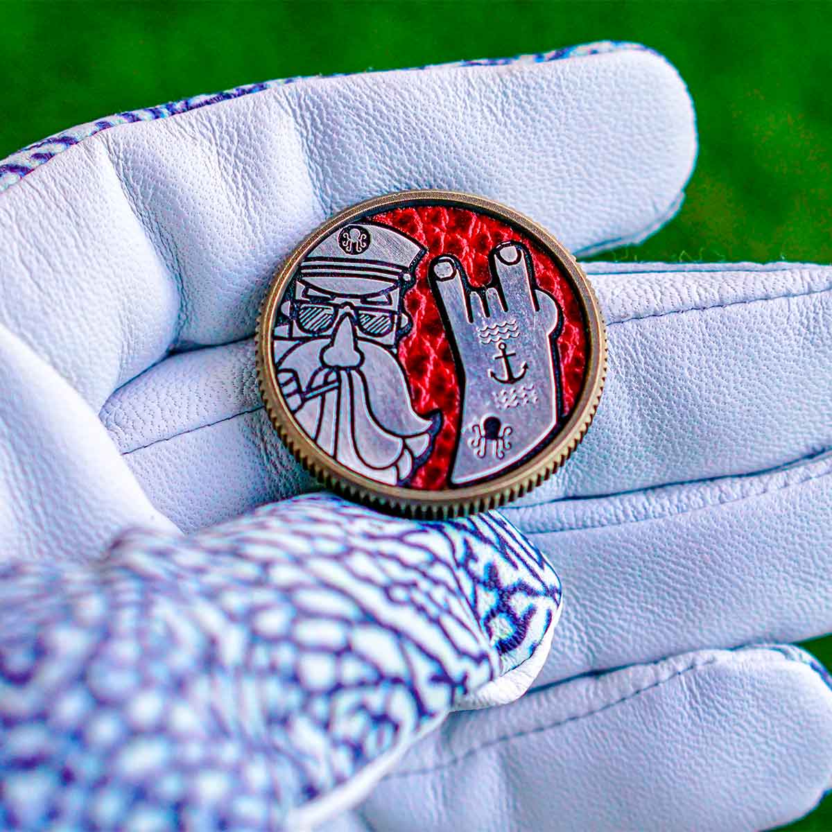 Kraken Captain design on Ryder Cup golf ball marker with shades, beard, tattooed arm, and red Dollaro leather inlay