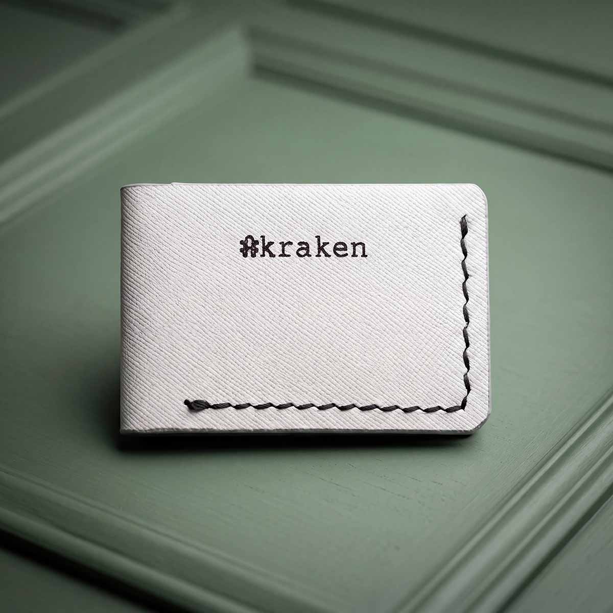 Kraken golf ball marker holder in white Italian veg-tan leather with black foil stamped Kraken mark