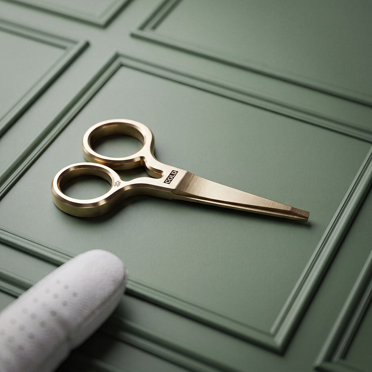 Solid brass King Cold pitch tool with COLD milled at the pivot, brushed satin finish, resting on green paneled surface