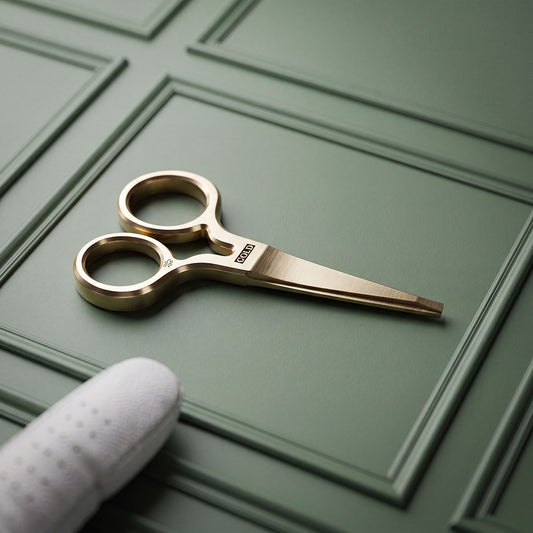Solid brass King Cold pitch tool with COLD milled at the pivot, brushed satin finish, resting on green paneled surface