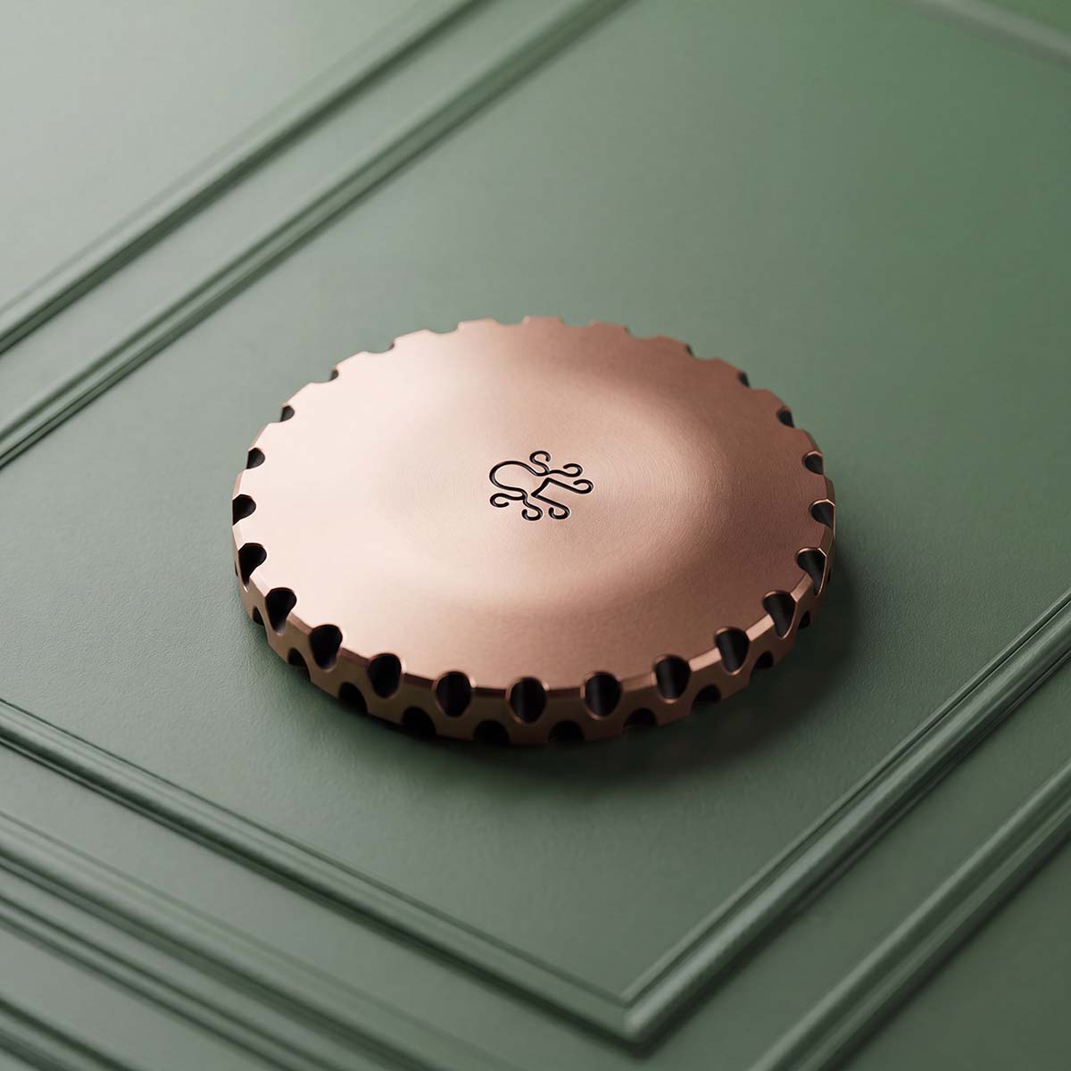 The Awakening copper golf ball marker — reverse engraved with the Kraken mark on milled copper, EDC scalloped edge