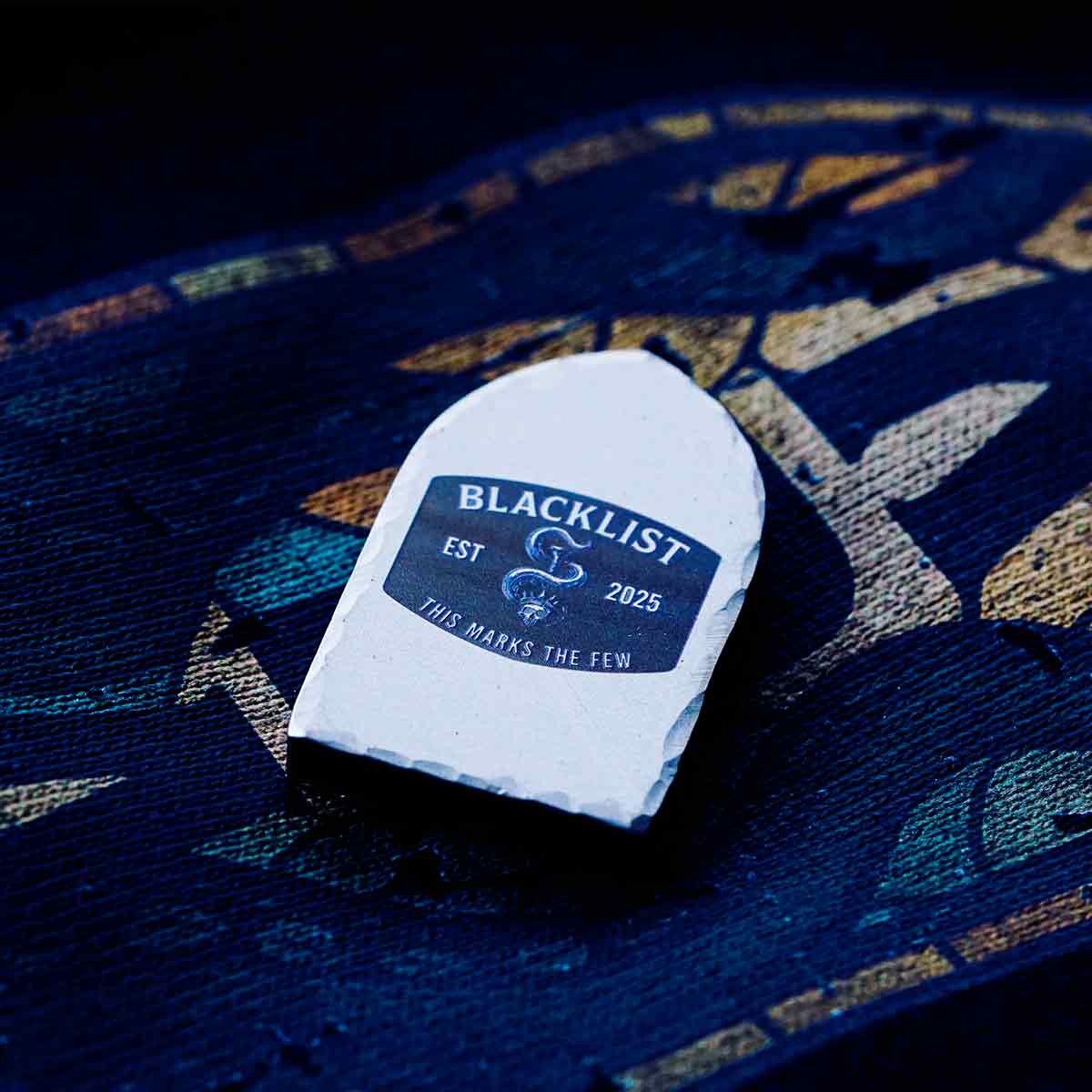 limited edition blacklist golf marker on textured fabric
