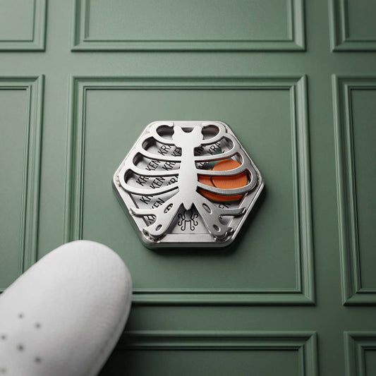 Kraken Golf Caged Peach limited edition hexagonal stainless steel golf ball marker with micro-welded rib cage and engraved KRAKEN cavity — Blacklist Masters Drop