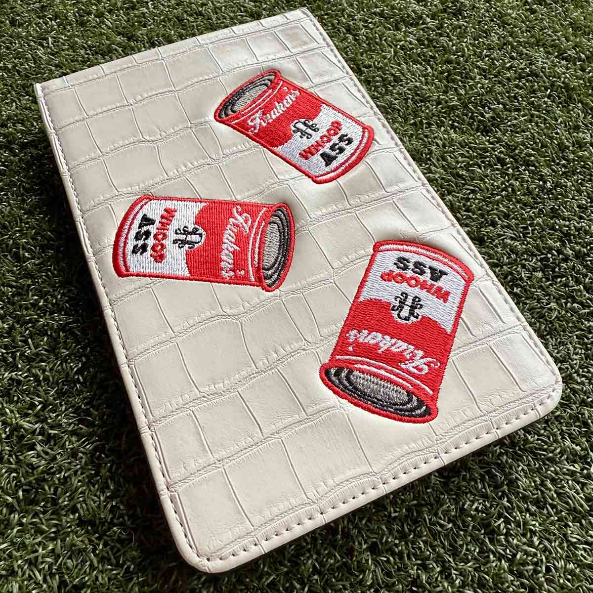 Back pocket fit of Whoop Ass yardage book holder on golf course