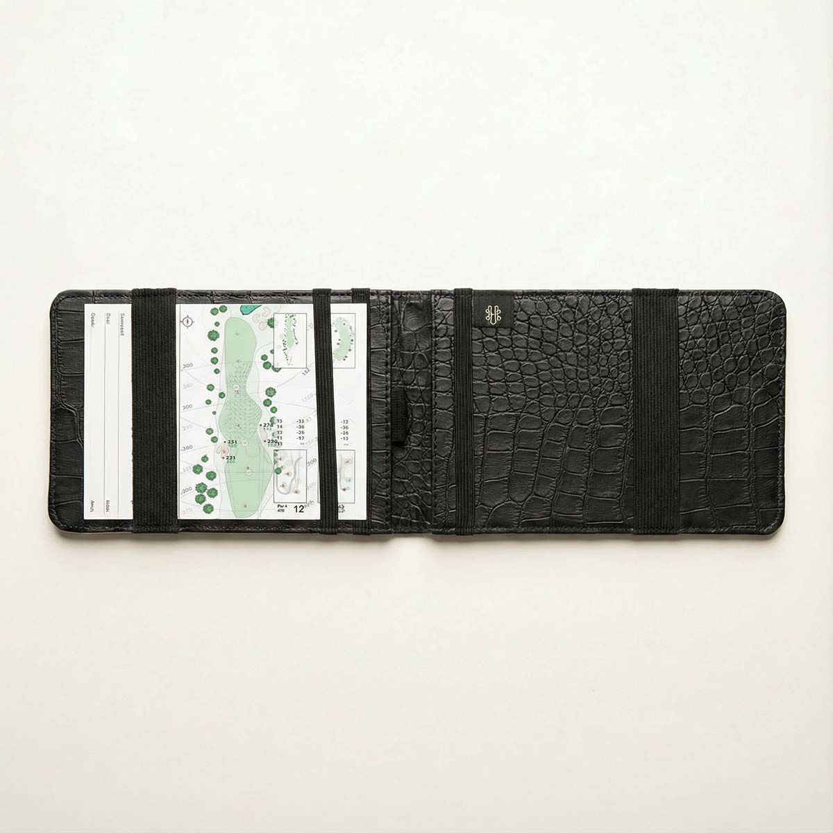 Black crocodile-patterned yardage book with scorecard slots on a white background