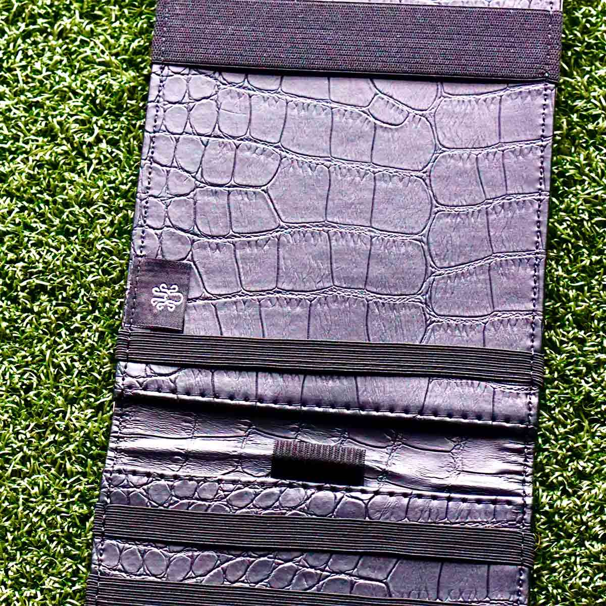 Black crocodile embossed interior of golf yardage book holder - open view
