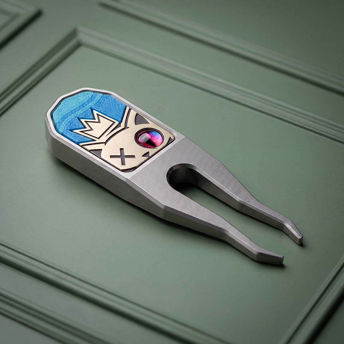 THIRD LIFE King Cold stainless steel pitch tool with brass crowned cat inlay, red eye and blue aqua resin background