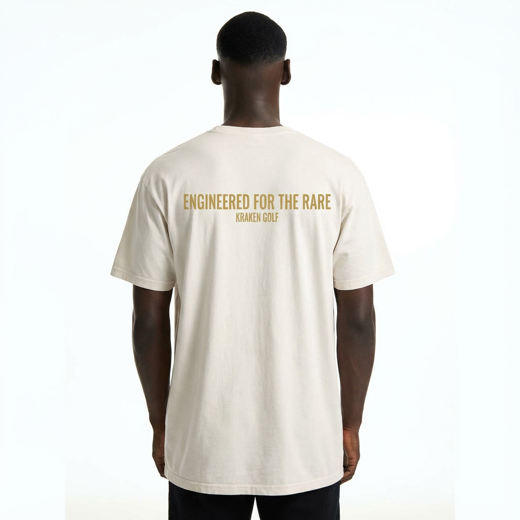 Craig wearing an ivory Kraken Rare t-shirt with 'Engineered for the Rare' text on the back, brand 'Kraken Golf' visible.