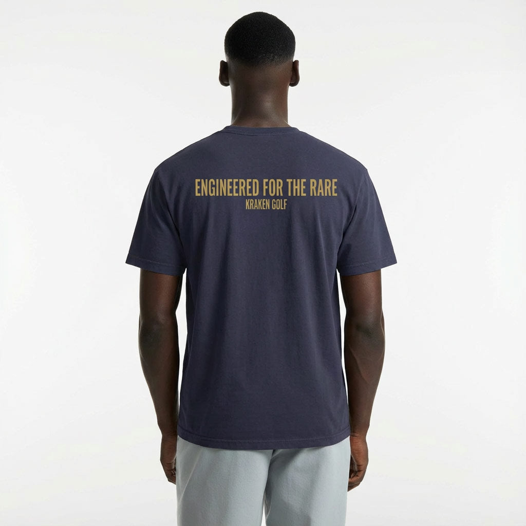 Craig wearing a navy blue Rare t-shirt with 'Engineered for the Rare' text on the back, on a white background