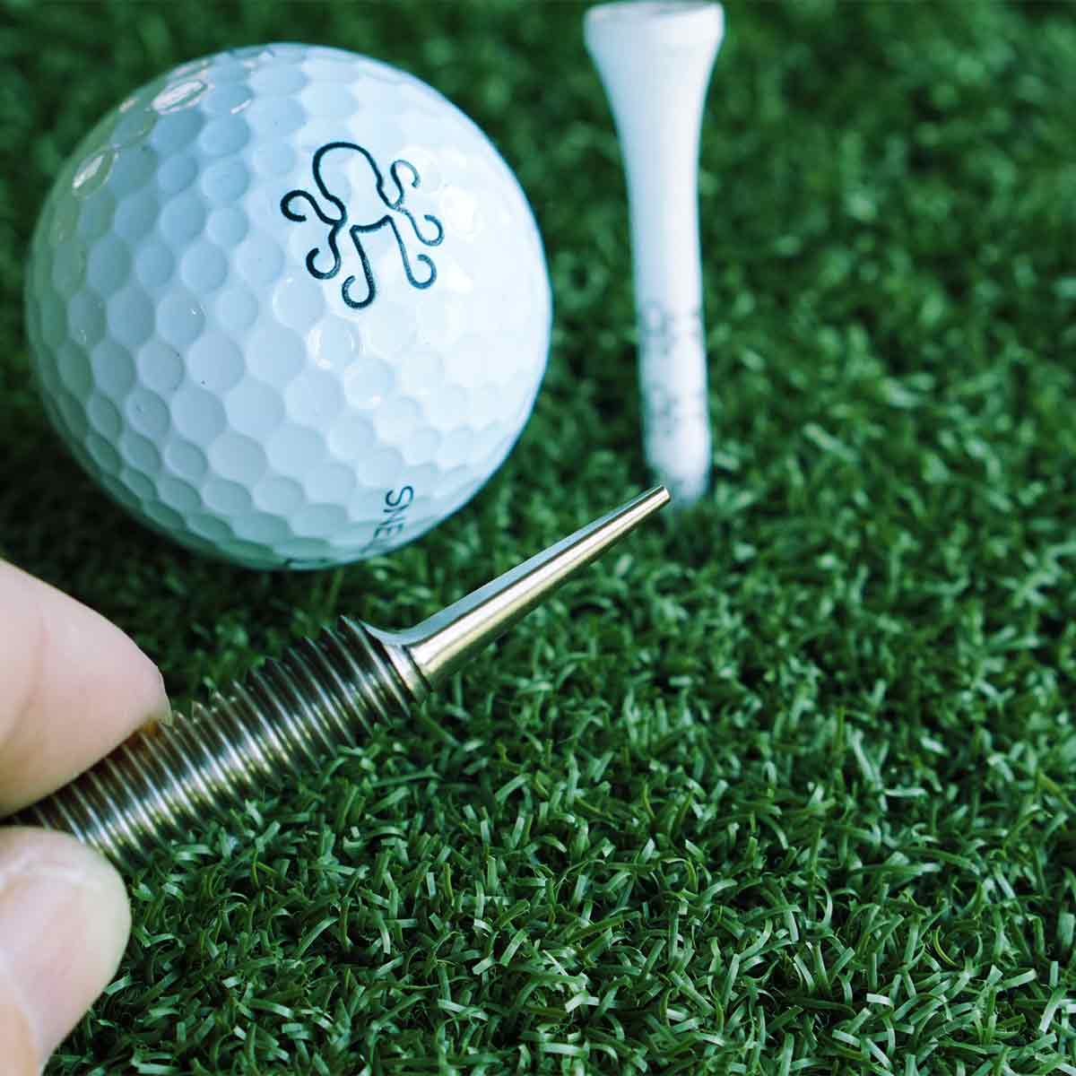 Stainless steel bolt-style divot tool with Kraken branding nut