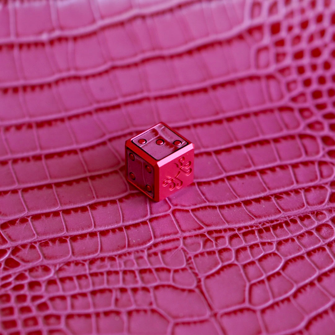 Detailed view of pink croc embossed veg tan leather inlay on Kraken Golf Strawberry Sherbet Die Marker