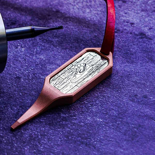 Copper golf pitch tool with brass inlay featuring Air Kraken I sneaker engraving on hardwood background