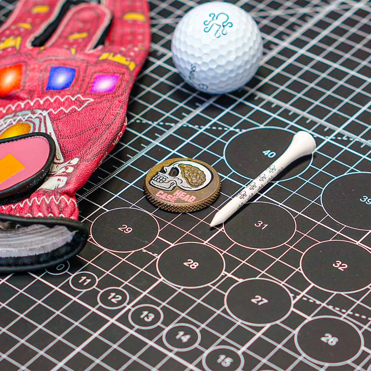 Knurled edge Head Case golf marker engraved with brain and golf elements