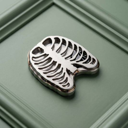 Stainless steel golf ball marker rib cage cutout with blackened steel Kraken floating inside the chest cavity — Heartless II by Kraken Golf