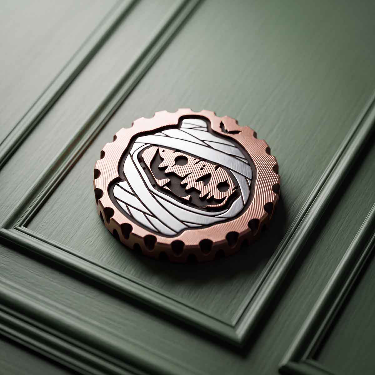 HOLLOWED copper golf ball marker with stainless steel mummy wrap inlay over a blackened jack-o-lantern face