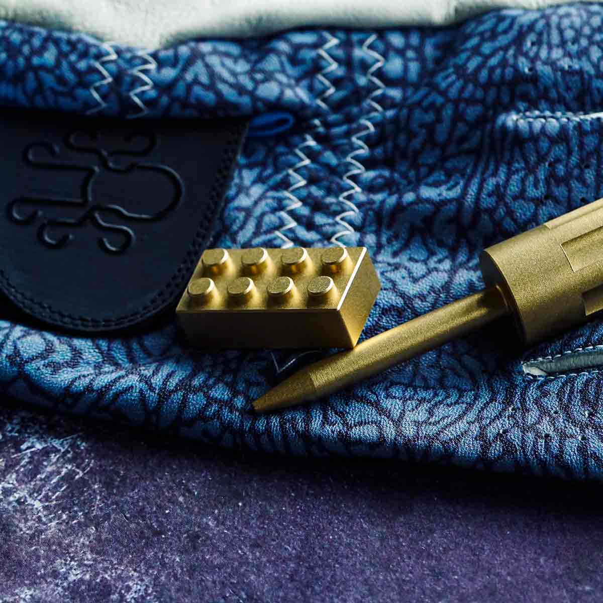 brass golf ball marker shaped like a block by Kraken Golf