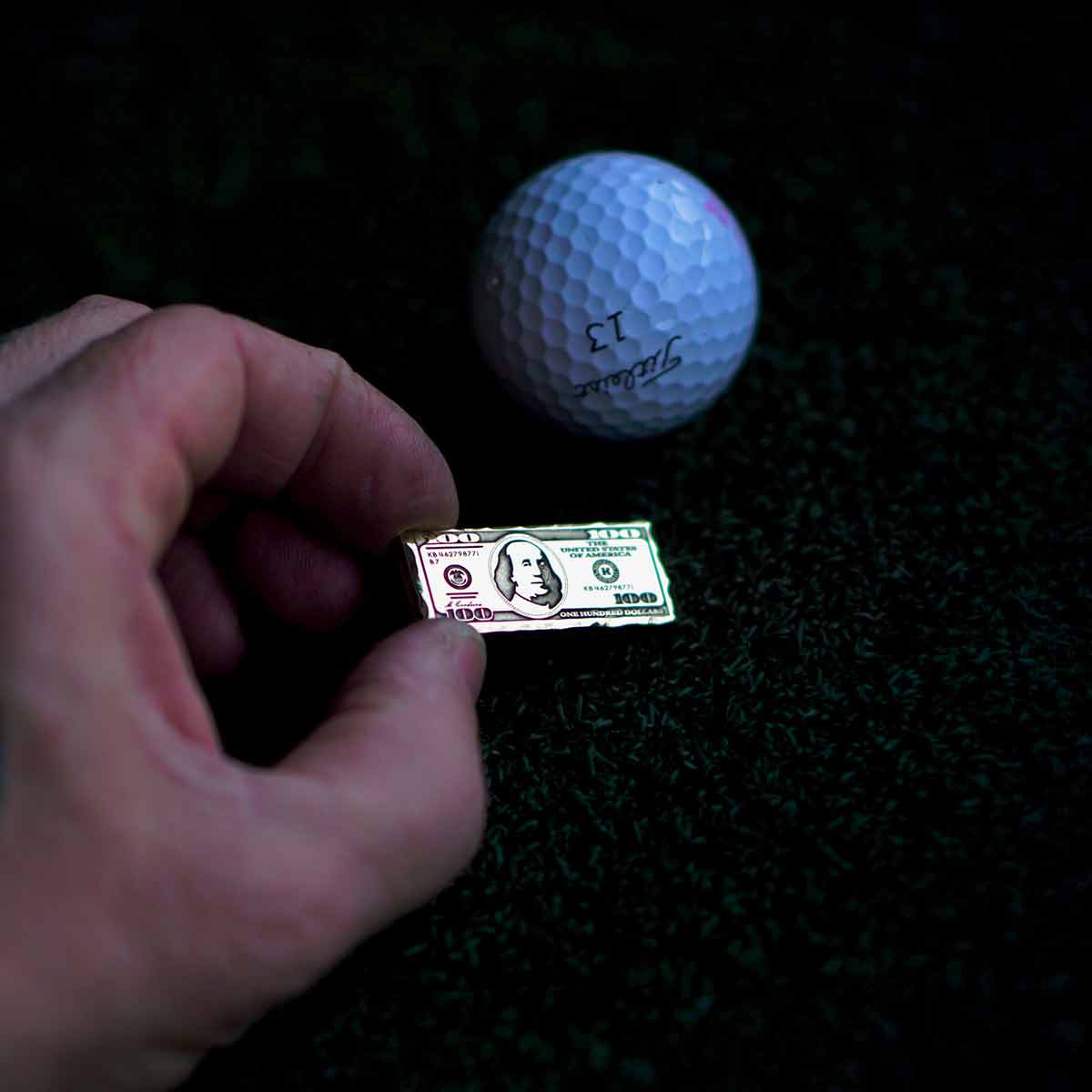 High-gloss handcrafted golf marker resembling a hundred dollar bill