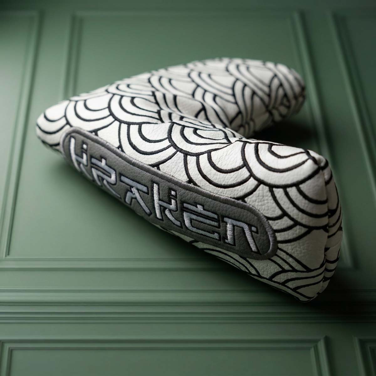 Angled view of white Seigaiha blade putter headcover showing full-coverage wave embroidery on both sides