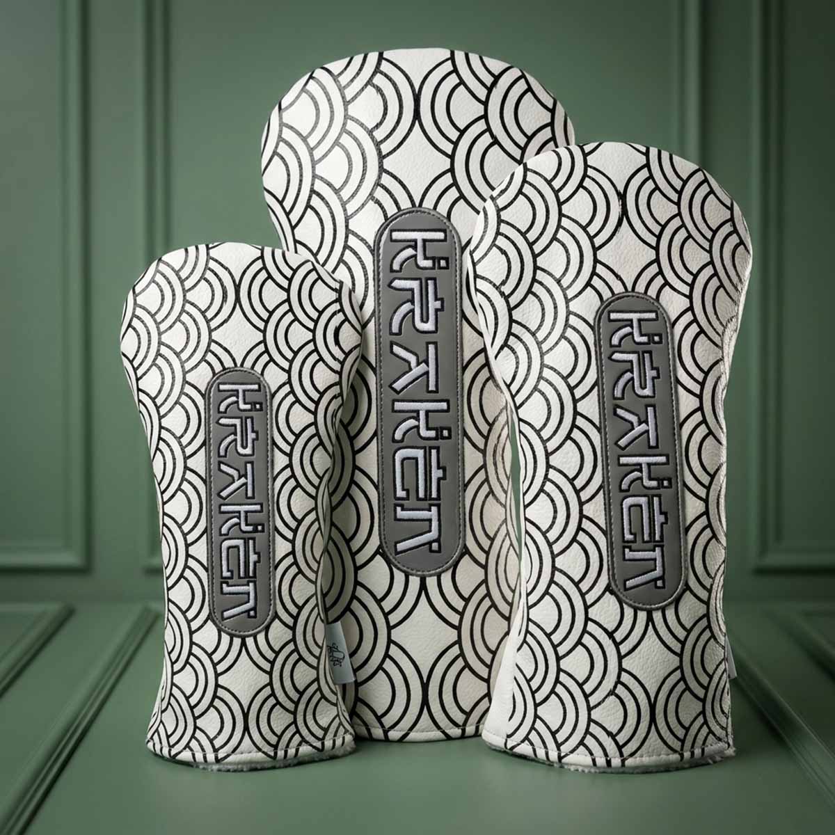 White driver, fairway, and hybrid headcovers with black embroidered Japanese wave pattern and vertical graphite KRAKEN badges