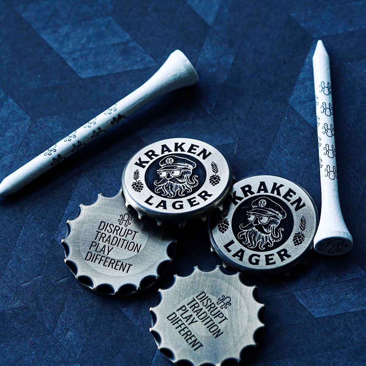 Kraken Golf Lager ball markers on a dark background