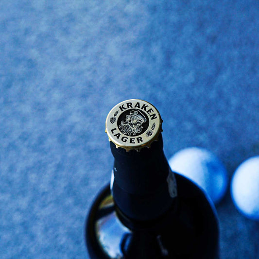Kraken Lager golf ball marker in brass shaped like a beer bottle cap