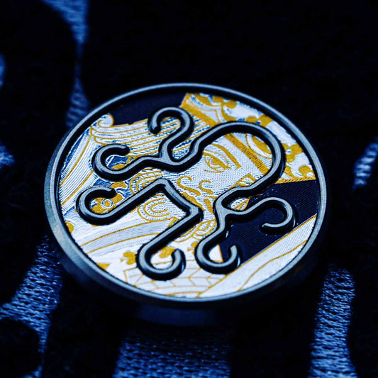 Closeup of waterproof black vinyl playing card inlay on Kraken golf marker


