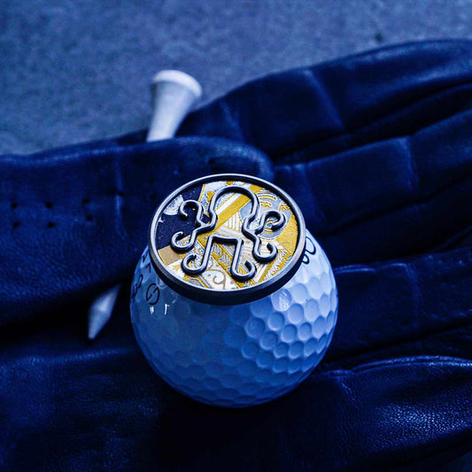 waterproof black vinyl playing card inlay on Kraken golf marker sitting on a golf ball