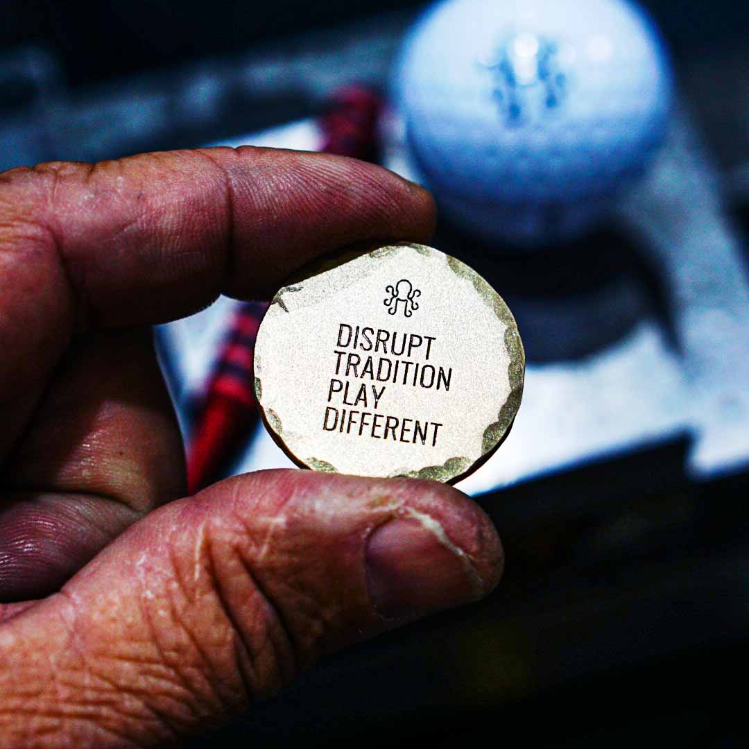 Kraken Golf relic-style brass marker with hammer-textured edge and marine engraving