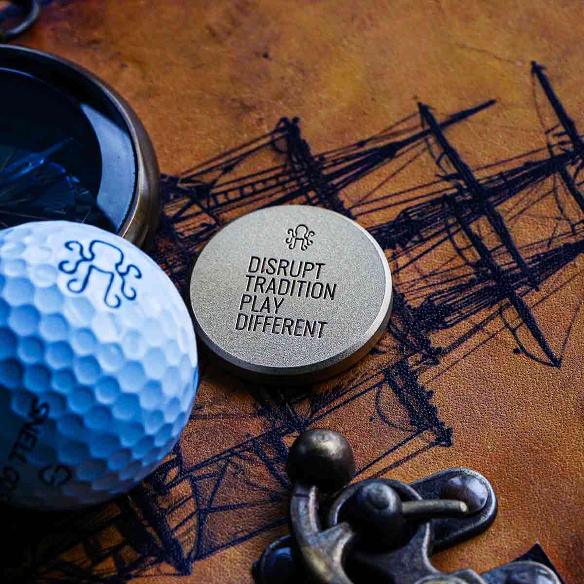The reverse side of the Leviathan Golf Ball MArker with the tag line DISRUPT TRADITION PLAY DIFFERENT