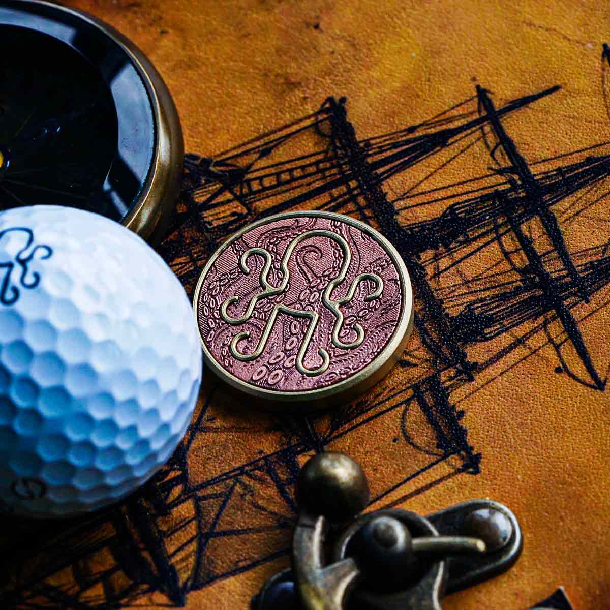 Leviathan Golf Ball Marker crafted by Kraken GOlf with a copper inlay inside a brass marker