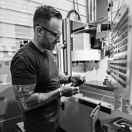 Behind-the-scenes shot: handcrafted golf accessory in progress on CNC mill