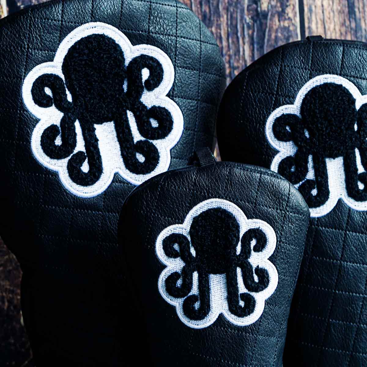 Full 3 - piece black quilted wood headcover set by Kraken Golf