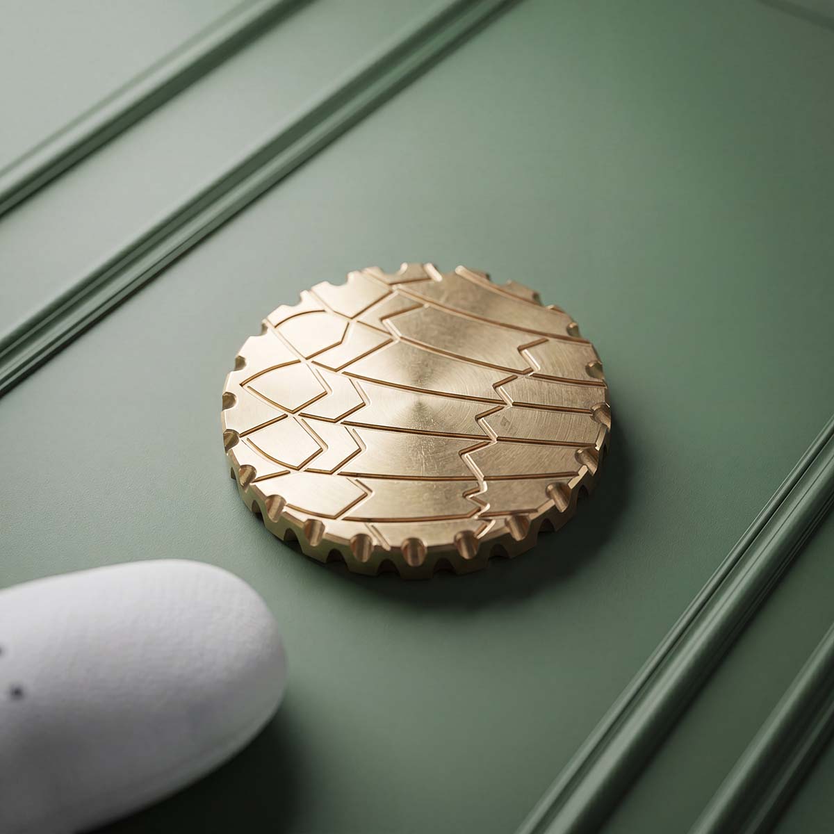 Reverse of the Open Season brass coin with a deep-relief design struck into polished brass