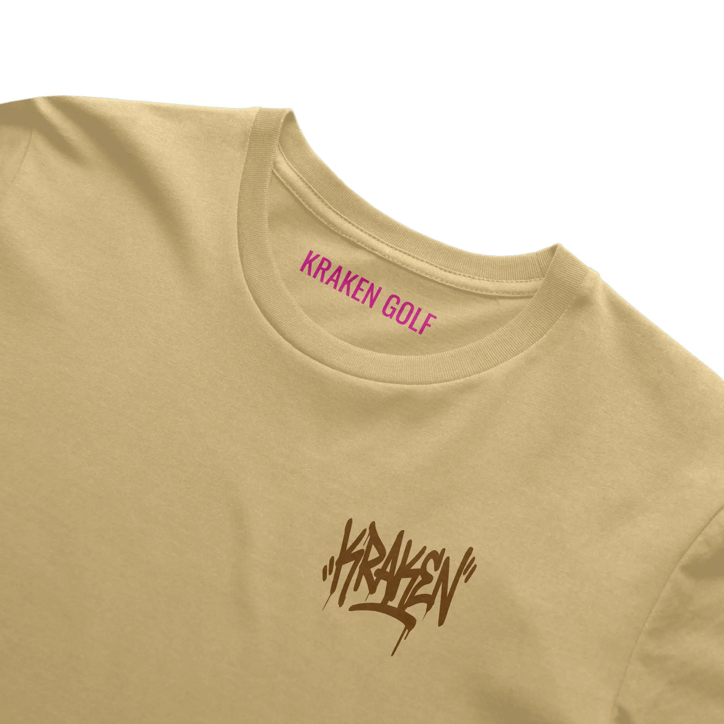 Left chest detail of the butter Origin tee showing the brown Kraken graffiti tag on heavyweight garment-dyed cotton