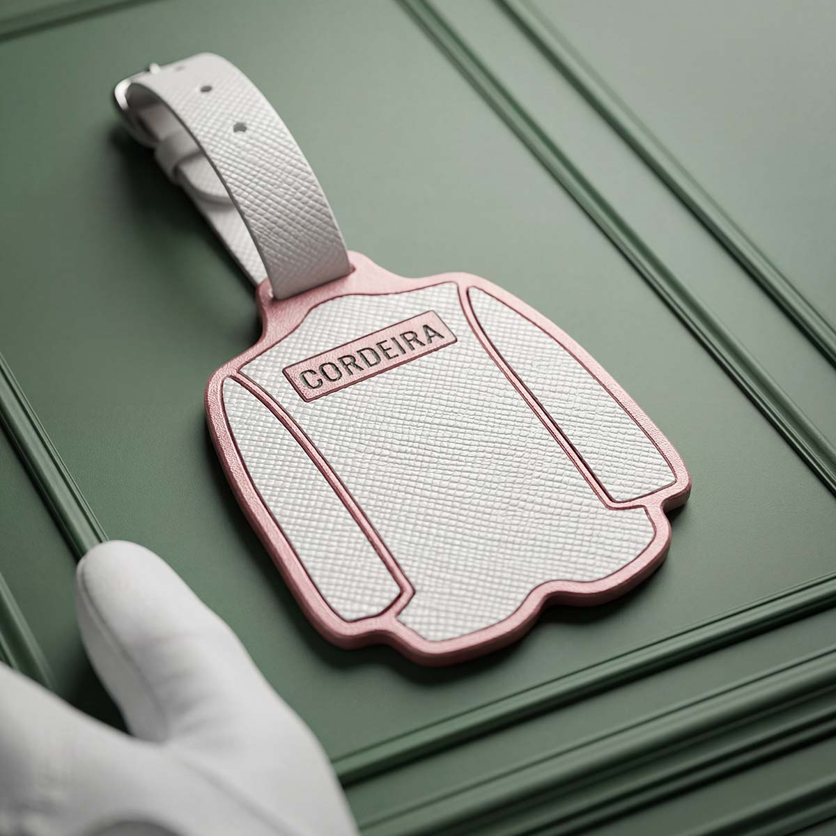 Back of Patron Pass Bag Tag with white caddie uniform design, custom engraved name area, and green paint fill