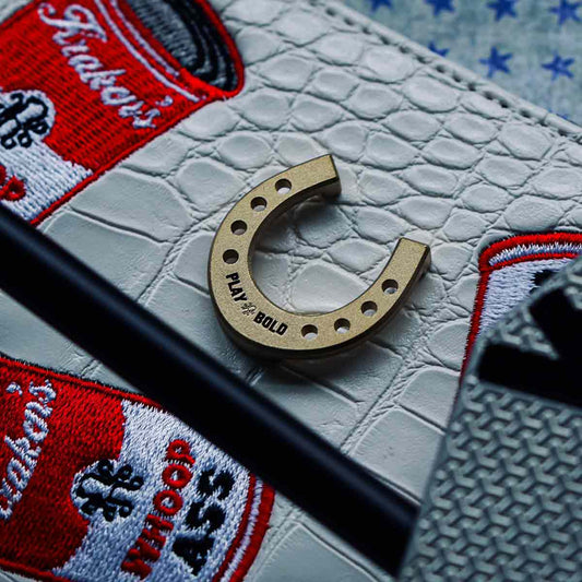 horseshoe golf ball marker with words PLAY BOLD