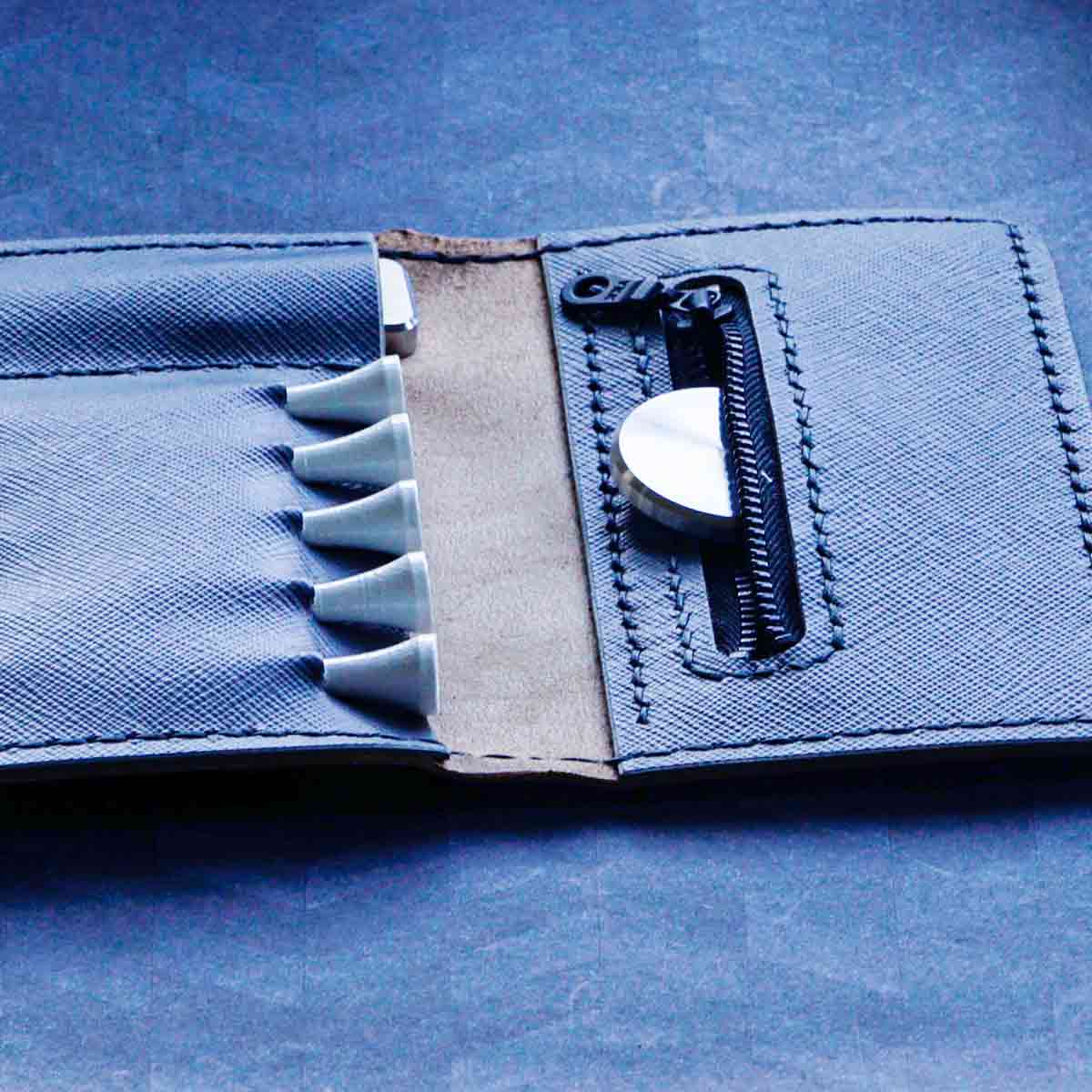 Inside view of Seve Tool Holder Blacklist Edition showing divot tool and tee slots with black-stamped Kraken logo